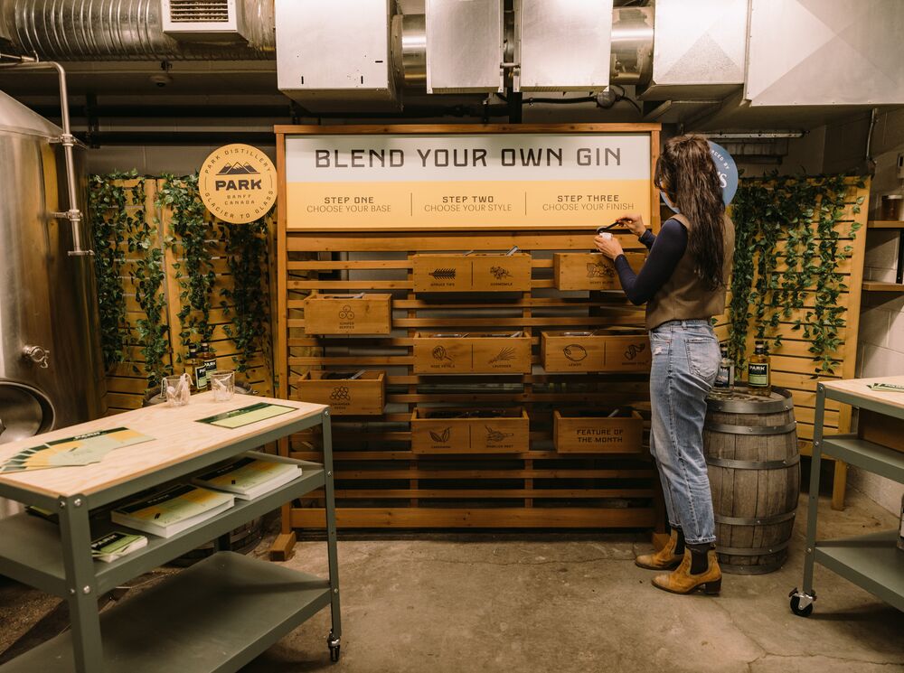 A woman tries the Blend your Own Gin experience at PARK Distillery in Banff National Park.